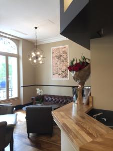 a living room with a couch and a table at La Cave de l'Avenue de Champagne in Épernay