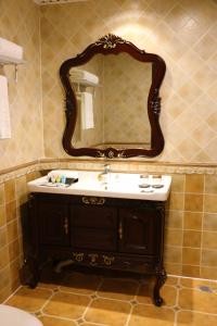 a bathroom with a sink and a mirror on the wall at Hohhot Level of Details in Hohhot
