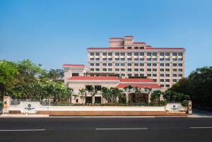 a large building in the background of a street at The Residency Towers Coimbatore in Coimbatore