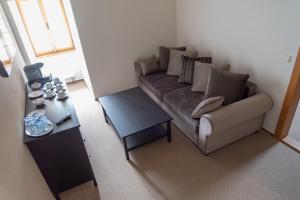 a living room with a couch and a table at Penzion Fojtstvi in Olomouc