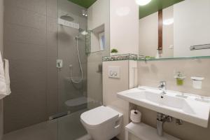 a bathroom with a toilet and a sink and a shower at Luxury Rooms and Apartment Silente Bacvice in Split +74 photos