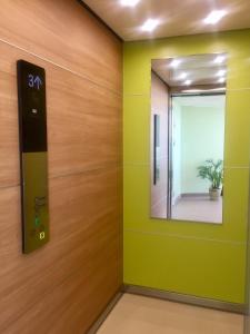 a elevator room with a mirror and green walls at Hotel Torslanda in Torslanda