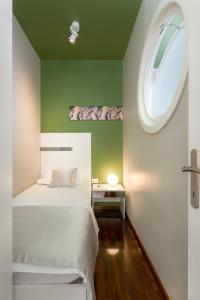 a bedroom with a white bed and a window at Luxury Rooms and Apartment Silente Bacvice in Split