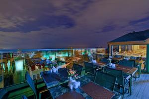 a balcony with tables and chairs and a view of the city at Hotel Perula in Istanbul