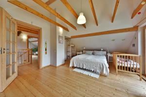 a bedroom with a bed and a crib at Atostogų namelis Druskininkuose in Druskininkai