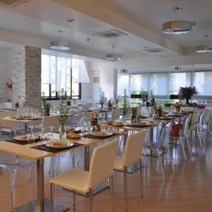a large dining room with tables and chairs at Hotel Monica in Riccione
