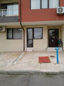 a house with a blue fire hydrant in front of it at Sea Apartment in Burgas