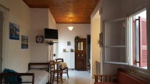 a bedroom with a bed and a tv on the wall at P & G Apartment in Pámfylla