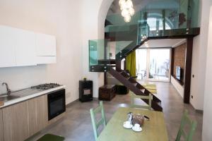 a kitchen with a spiral staircase in a room at Casa Nutrizione Apartment in Catania