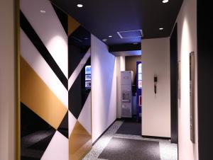 a hallway with a door leading into a room at Hotel Wing International Select Osaka Umeda in Osaka
