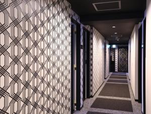 a hallway with a door leading to a stairway at Hotel Wing International Select Osaka Umeda in Osaka