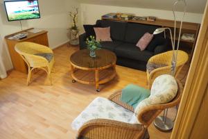 a living room with a couch and chairs and a table at Alpina Inzell 108 - Chiemgau in Inzell
