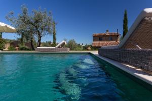 a swimming pool with blue water in a house at Villa Ligheia in Gambassi Terme