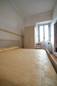 Postel nebo postele na pokoji v ubytování Hotel Dorico