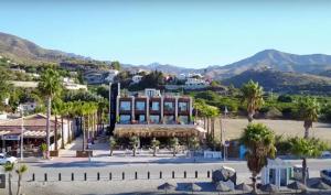 a view of a town with palm trees and a building at H Boutique Peña Parda in La Herradura