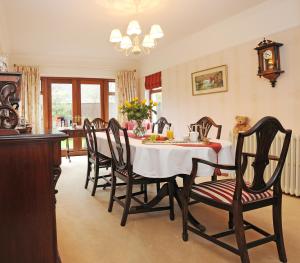 a dining room with a table and chairs at Cottesmore Bed and Breakfast in Bushmills