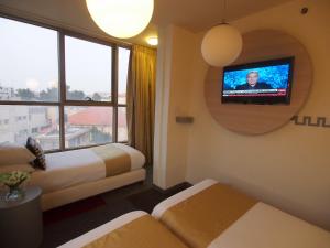 Ένα ή περισσότερα κρεβάτια σε δωμάτιο στο Grand Park Hotel Jerusalem