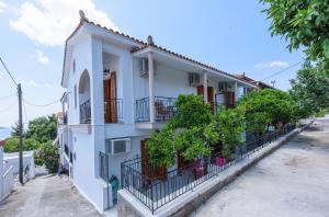 a white house with balconies on a street at Oasis 2 in Neo Klima