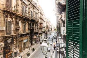 a city street with buildings and a street light at Case Barbera Via Parlamento by DomuSicily in Palermo