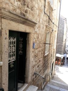 an entrance to a brick building with a black door at House Nina in Dubrovnik