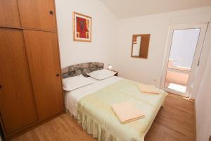 Postel nebo postele na pokoji v ubytování Apartments Mira