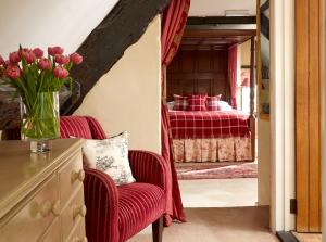 a room with a bed and a dresser at Burford House in Burford