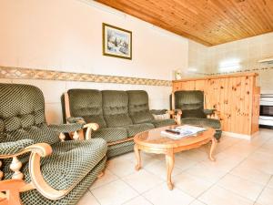 a living room with couches and a coffee table at Beautiful holiday home in Argeliers with pool in Argeliers