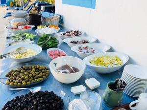 a blue table topped with bowls and plates of food at Dove Apart Hotel in Fethiye