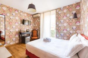 a bedroom with a bed and a wall covered in hearts at Salotto Monti in Rome