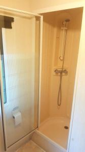 a bathroom with a shower with a glass door at Camping de la Reuille in Fléré-la-Rivière