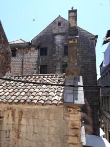 an old building with a chimney on top of a roof at House Nina in Dubrovnik