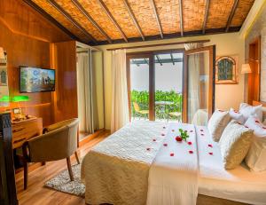 a bedroom with a large bed with roses on it at Bellapais Gardens in Kyrenia