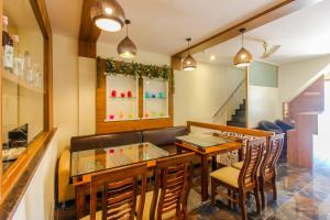 a dining room with a table and chairs at Blossom Dormitory For Male and Female in Mumbai