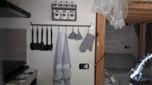 a refrigerator with utensils hanging on a wall at l'arco di Sersa in Riccò del Golfo di Spezia