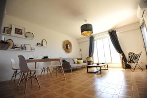 Una sala de estar con una mesa y sillas y un sofá. en T2 Terrasse Vue Mer - Route des Sanguinaires, en Ajaccio 12 fotos más