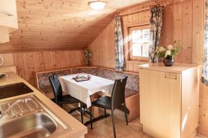 a kitchen with a table and chairs in a cabin at Oberhabererhof in Santa Maddalena in Casies