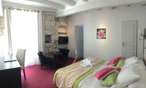 a room with a bed, chair, table and a lamp at Best Western Hôtel De France in Chinon