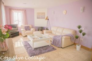 a living room with two couches and a coffee table at Cosy Skye Cottage in Kingsburgh