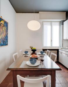 a dining room with a table and chairs and a kitchen at Buona Luce in Verona