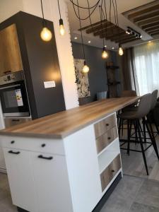 a kitchen with a white counter with a wooden counter top at Exclusive-Luxury Mihajlovic Apartment-STRICT&CENTRE in Skopje