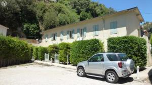Srebrny SUV zaparkowany przed budynkiem w obiekcie Petit Studio, terrasse, jardinet, climatisation, wifi w Nicei