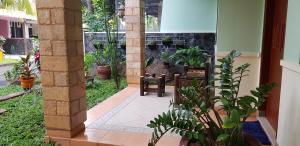 a patio with a table and chairs and plants at Rumah Satoe in Depok