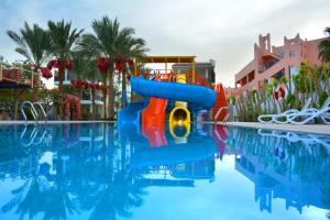 a water slide in the middle of a swimming pool at MinaMark Beach Resort for Families and Couples Only in Hurghada