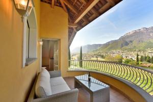 a living room with a couch and a balcony with a view at Villa Raifer in Appiano sulla Strada del Vino