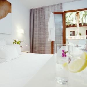 Un pat sau paturi într-o cameră la Petit Palace Hotel Tres