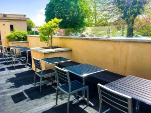 a row of tables and chairs on a patio at The Parkville Hotel in Hamilton