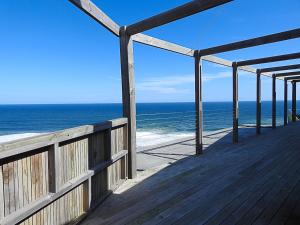 a wooden deck with a view of the ocean at Wilderness Beach Views in Wilderness