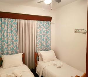 a room with two beds and a window at Wood and Stone Villa in Sani Beach