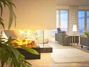 a rendering of a living room with a fireplace at "FIRST" Sellin Penthouse "Meerblick & SPA" in Ostseebad Sellin