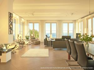 un soggiorno con divano e sedie di "FIRST" Sellin Penthouse "Meerblick & SPA" a Ostseebad Sellin